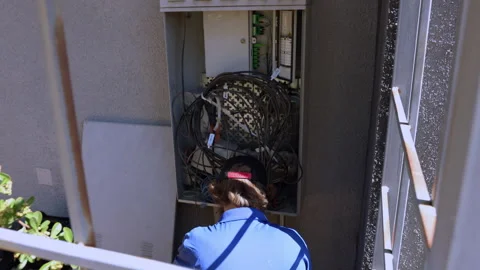 Cable technician is working at the Dmarc point Stockbeeldmateriaal 312358133