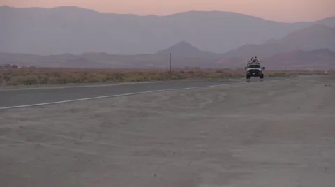 Cable truck drives down a desert highway Stock Footage 49044134