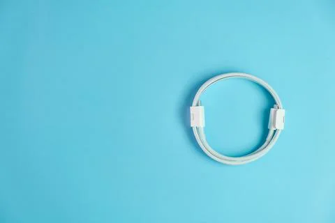 Cable with usb type C and lightening on the blue background with copy space. Stock Photos