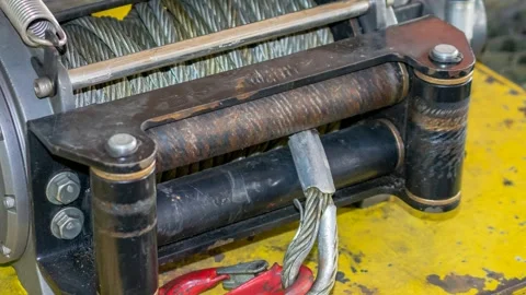 Cable winch mounted on a yellow sheet 스톡 동영상 302384887