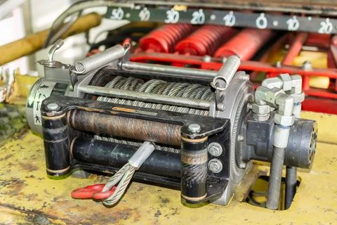 Cable winch mounted on a yellow sheet Stock Photos