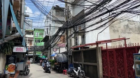 Cabled power and communication lines are seen in a Bangkok street, Thailand, 4K Stock Footage 201244404