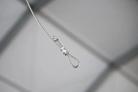 Cables and hook hanging from the Ceiling at the Construction site Stock Photos