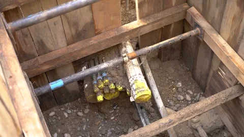 Cables and pipes cut during construction work on an open street Stock Footage 263645155