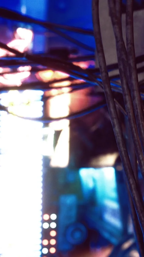 Cables connect equipment in a busy electronic workspace during daytime hours Stock Footage 332231706