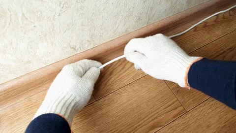 Cable's on the floor. Internet wire, electric wire along the wall, connection Stock-Footage 279605091