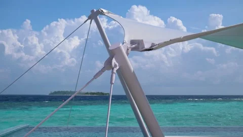 Cables hold structure in place for canopy next to ocean on tropical island Stock Footage 134432429