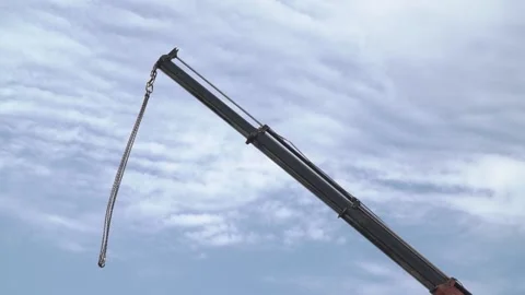 Cables with hooks on the end are hanging from a massive crane, construction Stock Footage 160811849