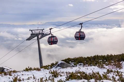 Cableway cabin above the clouds at sunset Stock Photos