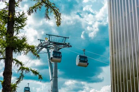 Cableway cabins at the pillar between the trees Stock Photos