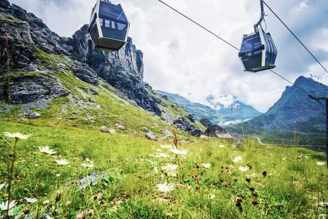 Cableway going over alpine meadow Stock Photos