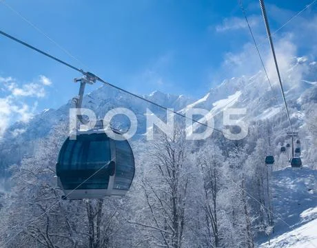 Cableway in the mountains above the forest Stock Photos
