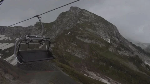 Cableway in the resort of Rosa Khutor in Sochi rides in the clouds Stock Footage 115495730