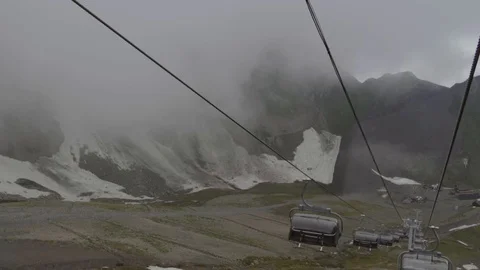 Cableway in the resort of Rosa Khutor in Sochi rides in the clouds Stock Footage 115495748