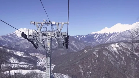 Cableway support and cabins at sunny day in mountains. Krasnaya Polyana, Russia Stock Footage 79090997