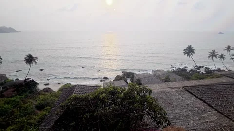 Cabo De Rama Beach Resort Shacks with Sunset Reflection on Ocean in South Goa Stock Footage 342832364