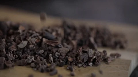 Cacao Nibs or Chips Falling on a Wooden Table Closeup Stock Footage 99163470
