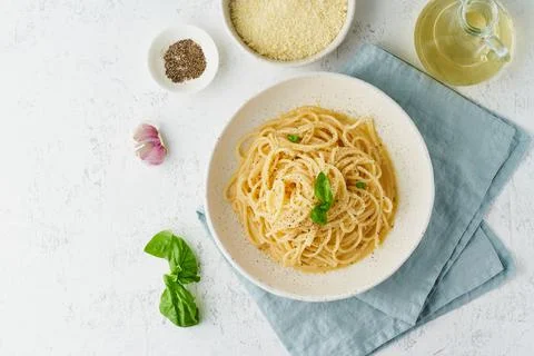 Cacio e pepe pasta. Spaghetti with parmesan cheese and pepper. Stock Photos