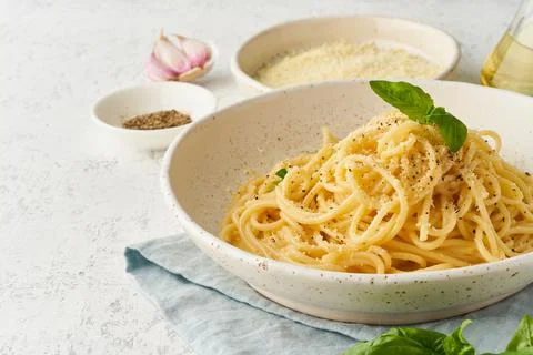 Cacio e pepe pasta. Spaghetti with parmesan cheese and pepper. Stock Photos