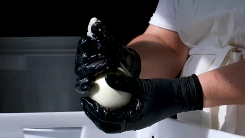 Caciocavallo kachakovala cheese preparation process female hands in black latex Stock Footage 274893738