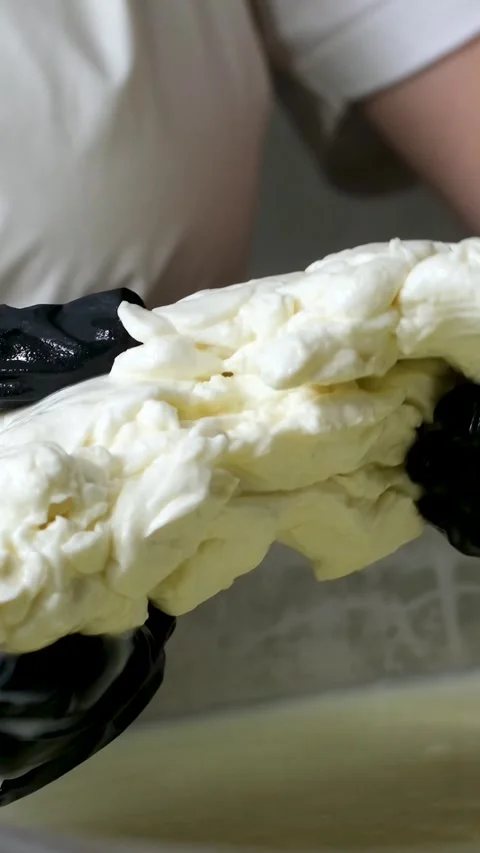 Caciocavallo kachakovala cheese preparation process female hands in black latex Stock Footage 275157858