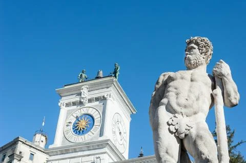 Caco statue with the background, the clock tower of the church.(17th century) Stock Photos