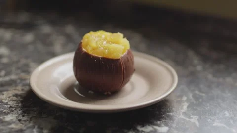 Cacos-shaped cake made of chocolate and passion fruit slices on a plate Stock Footage 300027201