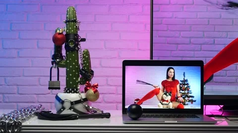 Cactus In accessories for BDSM games on the table with gifts next to the TV with Stock Footage 144748929