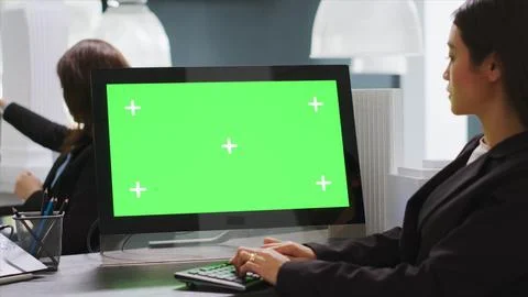Cad designer using PC with greenscreen at workstation area Stock Photos