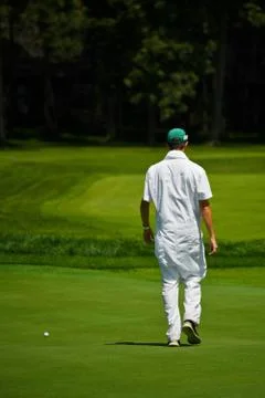 Caddy Walking onto Green Stock Photos