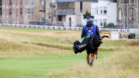 Caddy Walking on St Andrews Golf Course Stock Footage 296305213