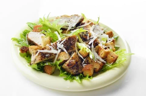 Caesar chicken salad on white background Stock Photos