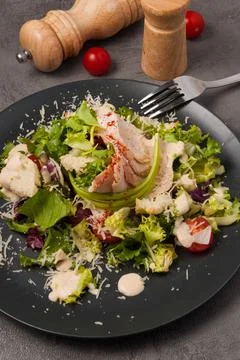 Caesar salad in an alternative modern serving on a black plate Stock Photos