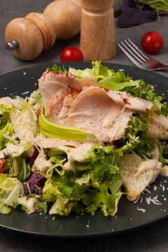 Caesar salad in an alternative modern serving on a black plate Stock Photos