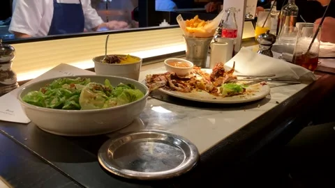 Caesar Salad And Chips Left Over After Meal In Restruant Stock Footage 219694634