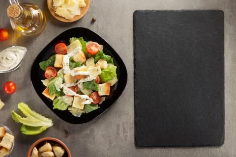 Caesar salad and ingredients at table Foto stock