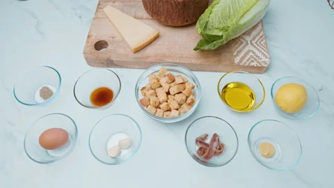 Caesar Salad and Sauce ingredients in 4k on the table ready for preparation. Stock Footage 140762844