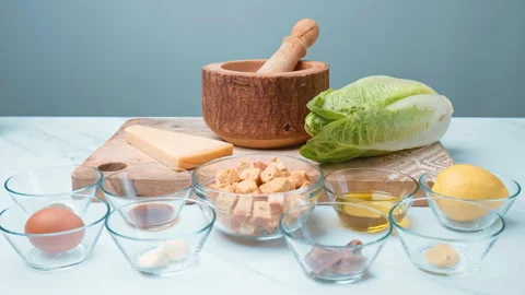 Caesar Salad and Sauce ingredients in 4k on the table ready for preparation. Stock Footage 140764464