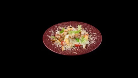 Caesar salad on black background, camera zoom in to close-up view Stock Footage 91031355