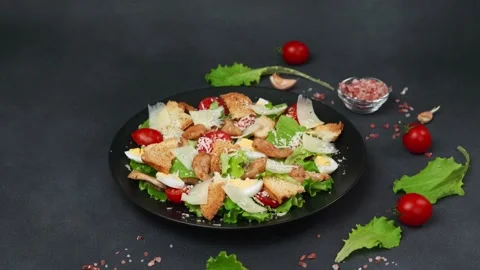 Caesar Salad in a black plate against a Black Background Video stock 237703443