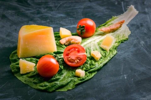 Caesar salad blanks. Parmesan cheese, croutons, chicken and tomatoes on a lea Foto stock