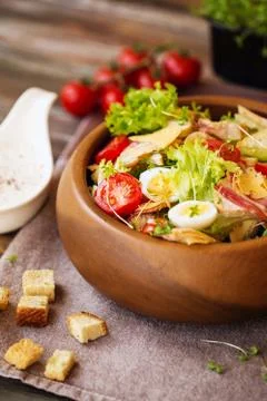 Caesar salad with cherry tomatoes and quail eggs Stock Photos