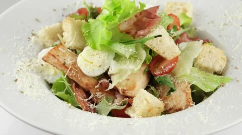 Caesar salad with chicken and quail eggs (loop) Stock Footage 56849925
