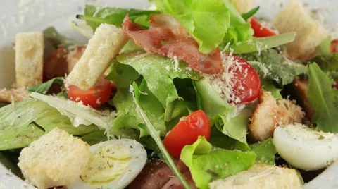 Caesar salad with chicken and quail eggs, closeup (loop) Stock Footage 56850067