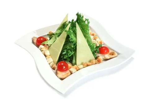 Caesar salad with chicken and triangular slices of parmesan. isolated on whit Stock Photos