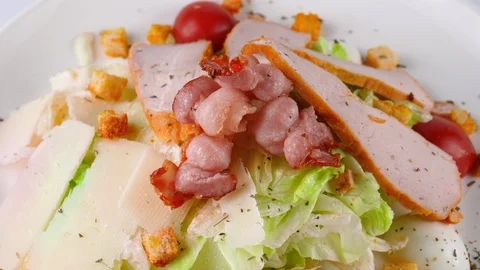 Caesar salad with chicken breast and bacon, quail eggs, parmesan cheese Stock-Footage 87326916
