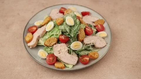 Caesar salad with chicken, cherry tomatoes, croutons, parmesan cheese, eggs. Stock Footage 320884179