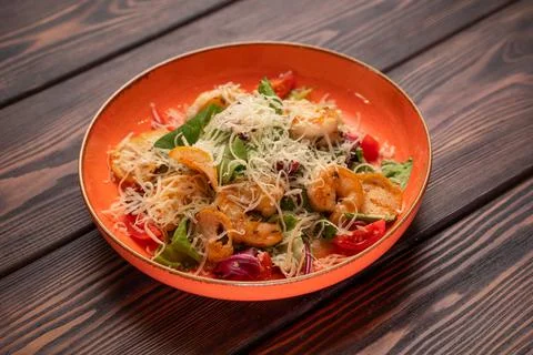 Caesar salad with chicken with grated cheese and cherry tomatoes Stock Photos