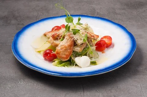 Caesar salad with chicken on a gray background Stock Photos