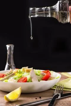 Caesar salad with chicken on a light natural table. Stock Photos